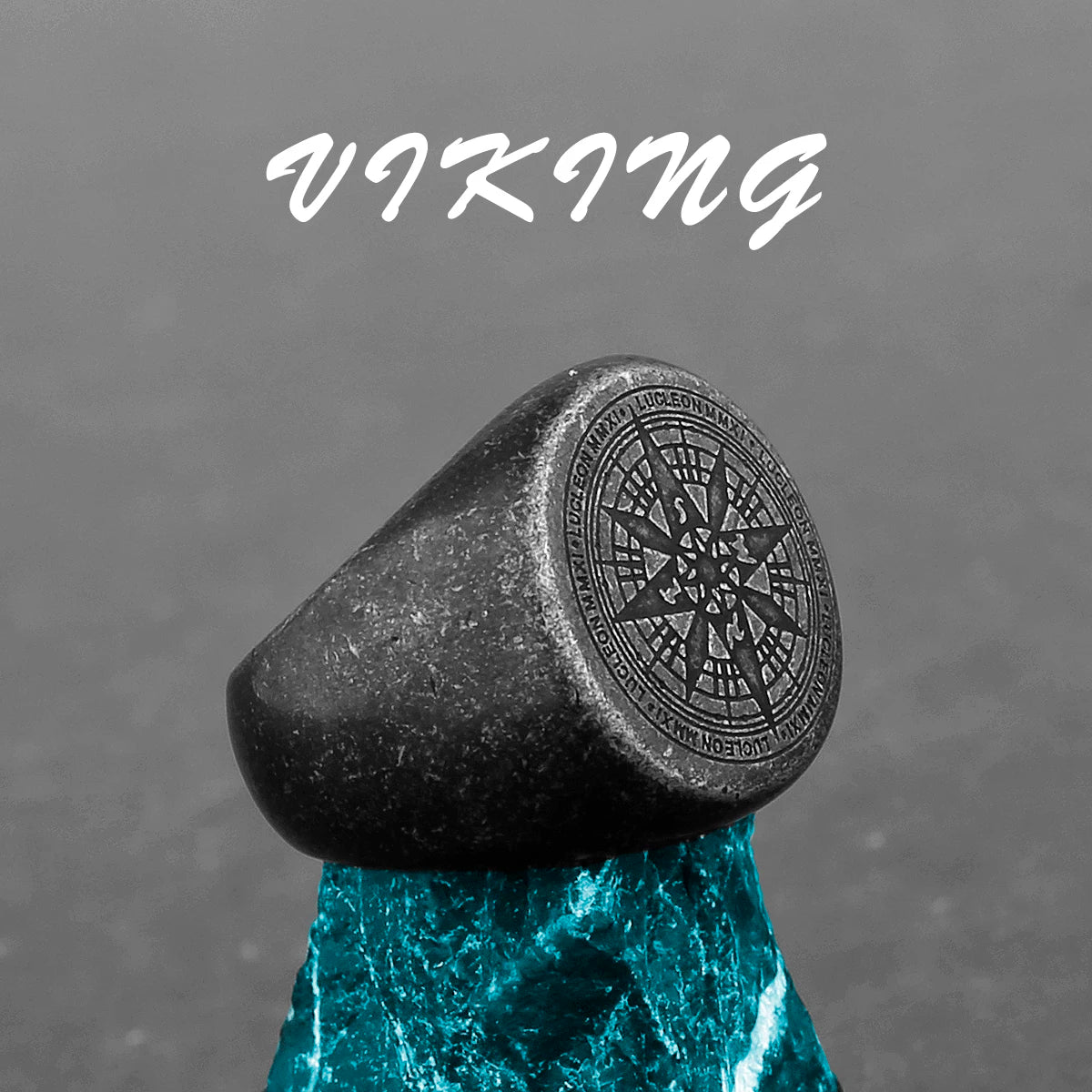 Black stone ring with engraved design on a gray background, featuring the word 'Viking'.