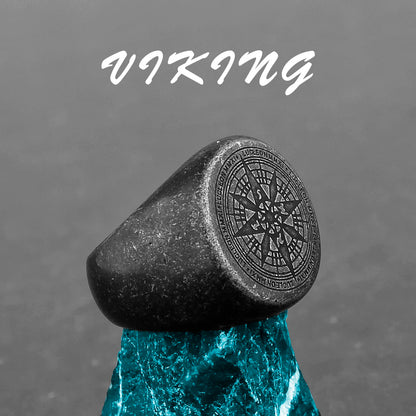 Black stone ring with engraved design on a gray background, featuring the word 'Viking'.