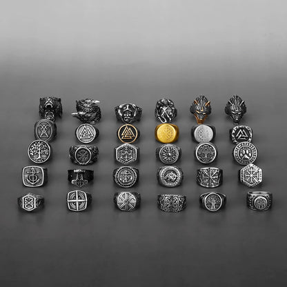 Collection of various rings with different designs on a gray background