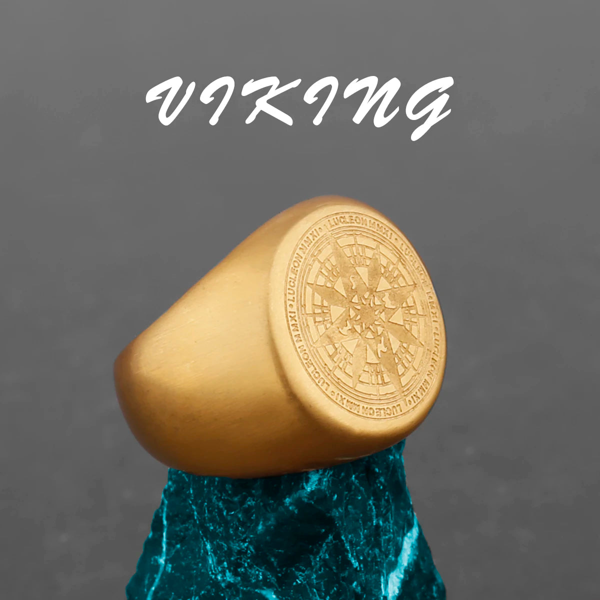Gold ring with compass design on a gray background with 'Viking' text.