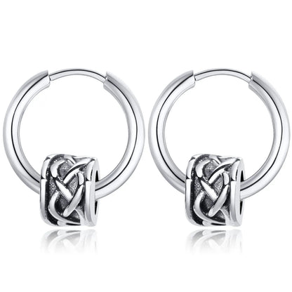 Pair of silver hoop earrings with an intricate knot design on a white background
