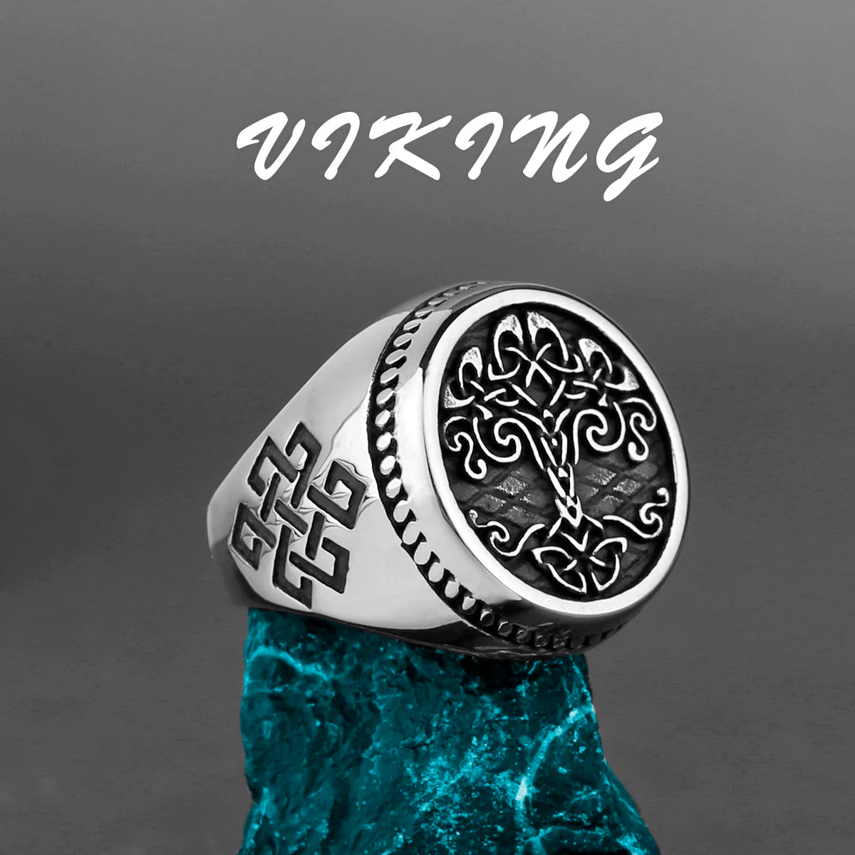 Silver Viking Tree of Life ring with intricate designs on a gray background