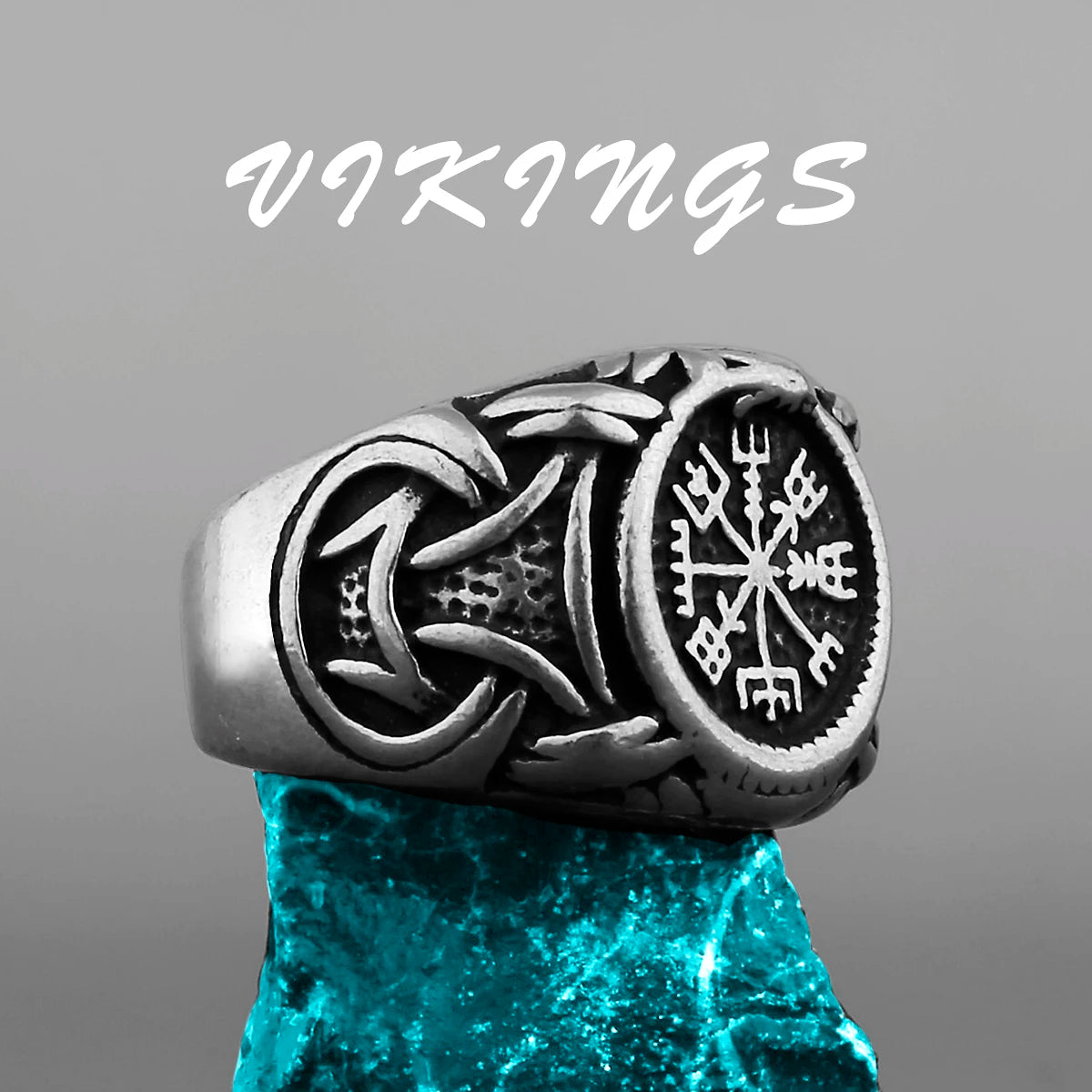 Silver Viking ring with intricate designs on a gray background