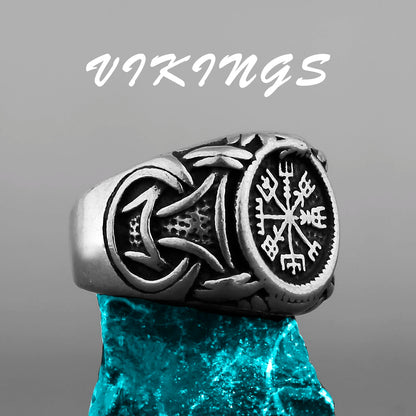 Silver Viking ring with intricate designs on a gray background