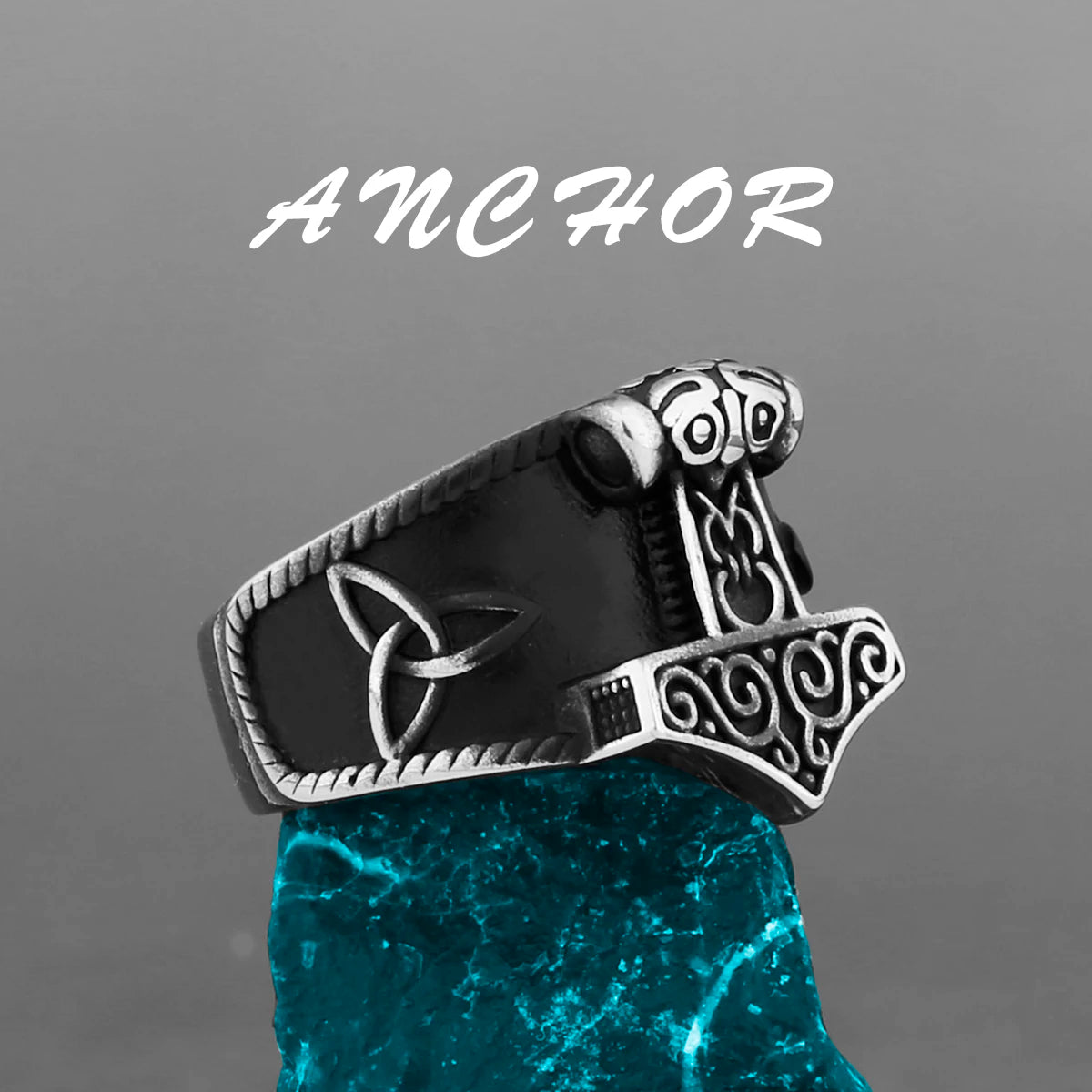 Silver ring with Thor's hammer design on a gray background