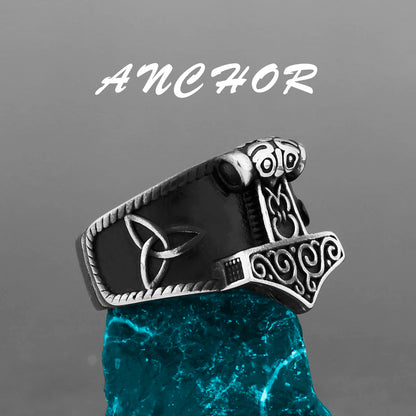 Silver ring with Thor's hammer design on a gray background