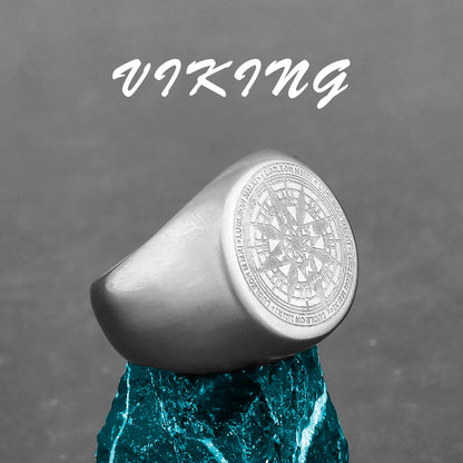 Silver ring with intricate design on a gray background with 'Viking' text