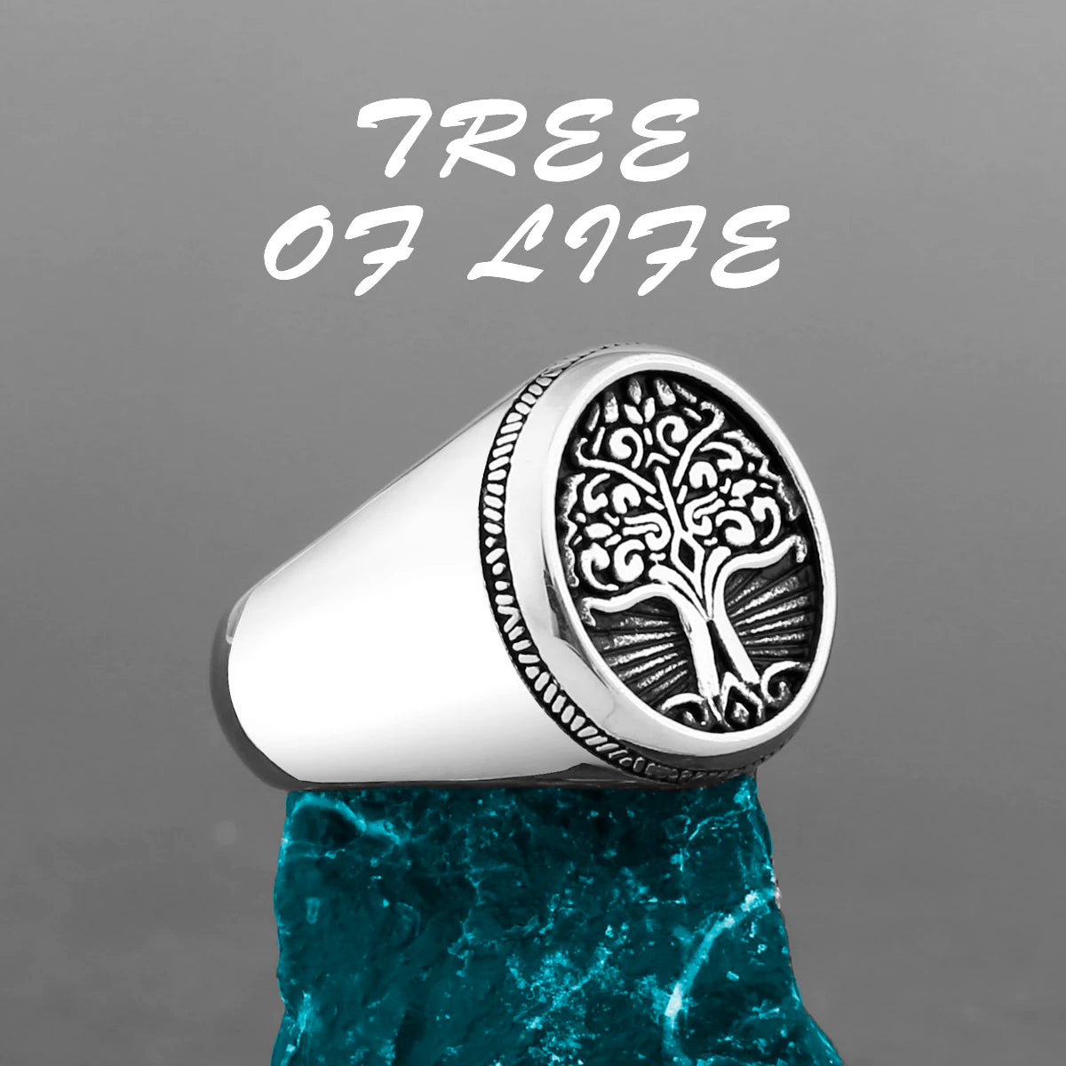 Silver ring with a tree design on a gray background