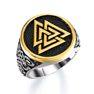 Ring with a gold and silver design on a white background