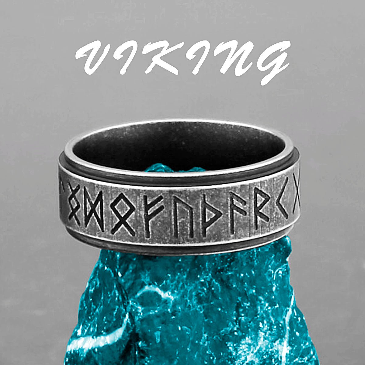 Nordic Viking stainless steel rune ring with ancient Norse inscriptions displayed on a blue stone.