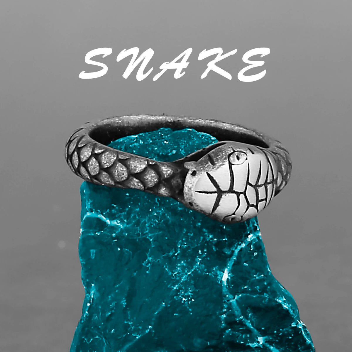 Nordic Viking snake ring with detailed scales and a silver snake head on a blue stone.